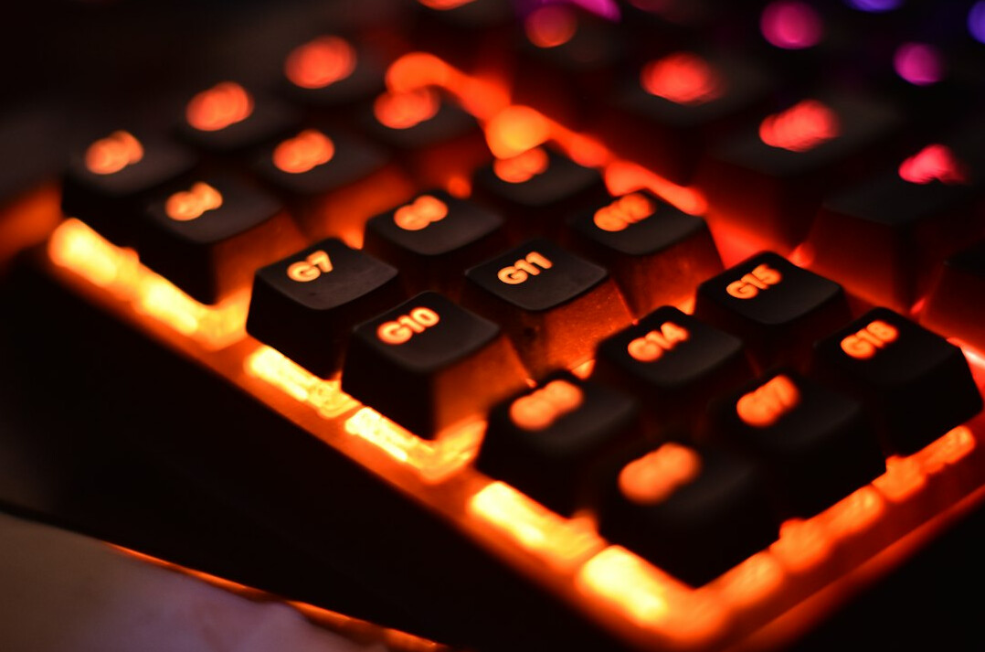Close up of hands typing on a mechanical keyboard